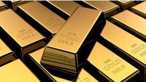 Mehrere Goldbarren, gestapelt und verstreut, jeder mit der Gravur „FEINGOLD 999,9“. Die Barren haben eine glatte, reflektierende Oberfläche, die ihren metallischen Glanz hervorhebt – ein wahrer Beweis für die Anziehungskraft von Edelmetallen wie Gold und Platin.